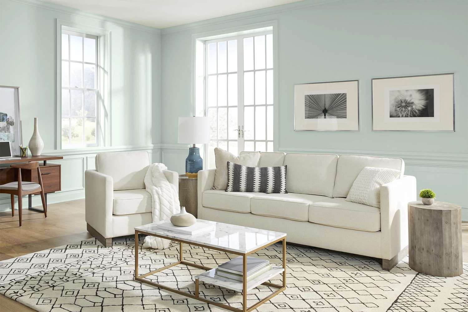 living room with white furniture and light blue-green walls