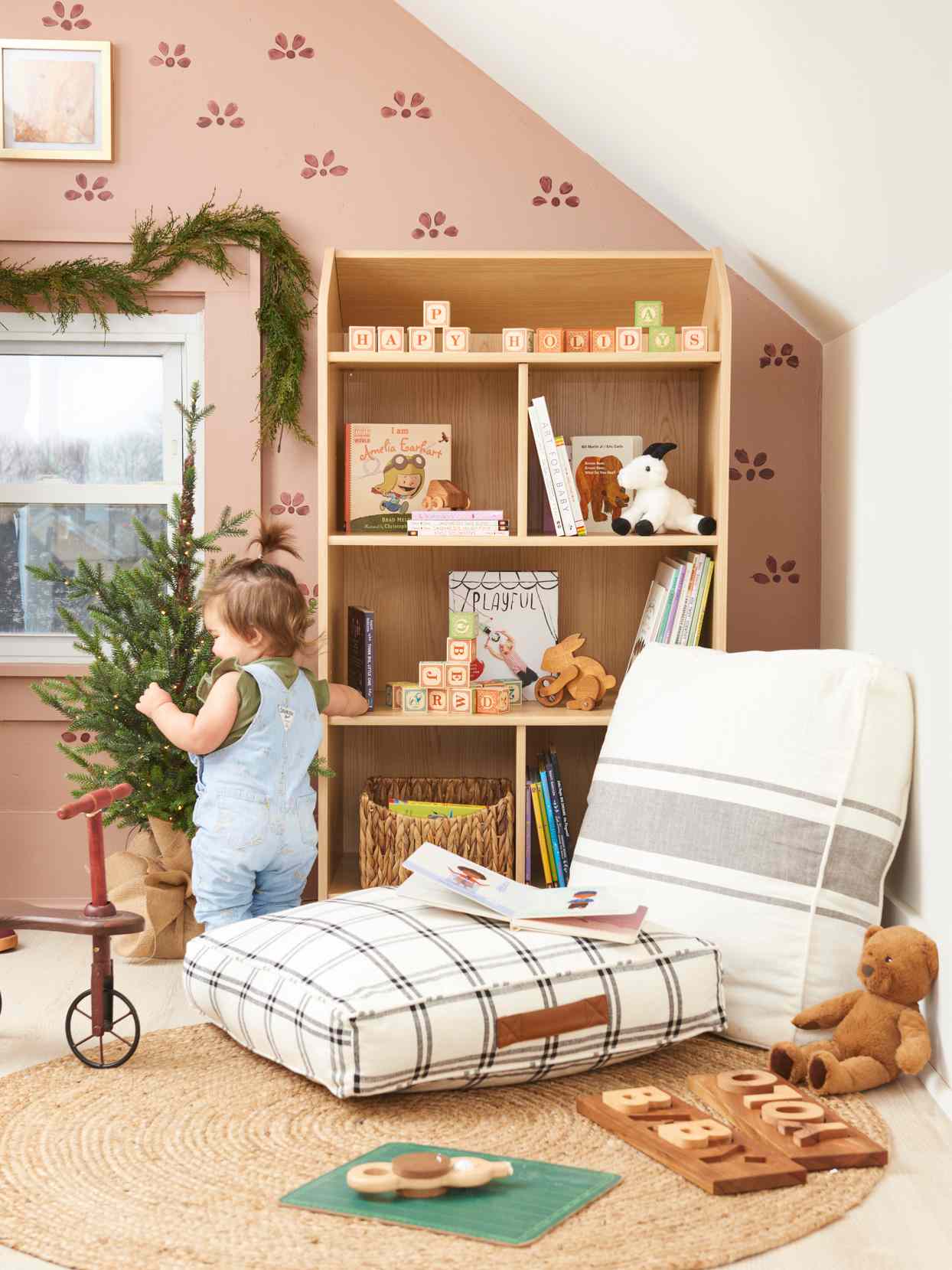 toddler playing in pink festive bedroom