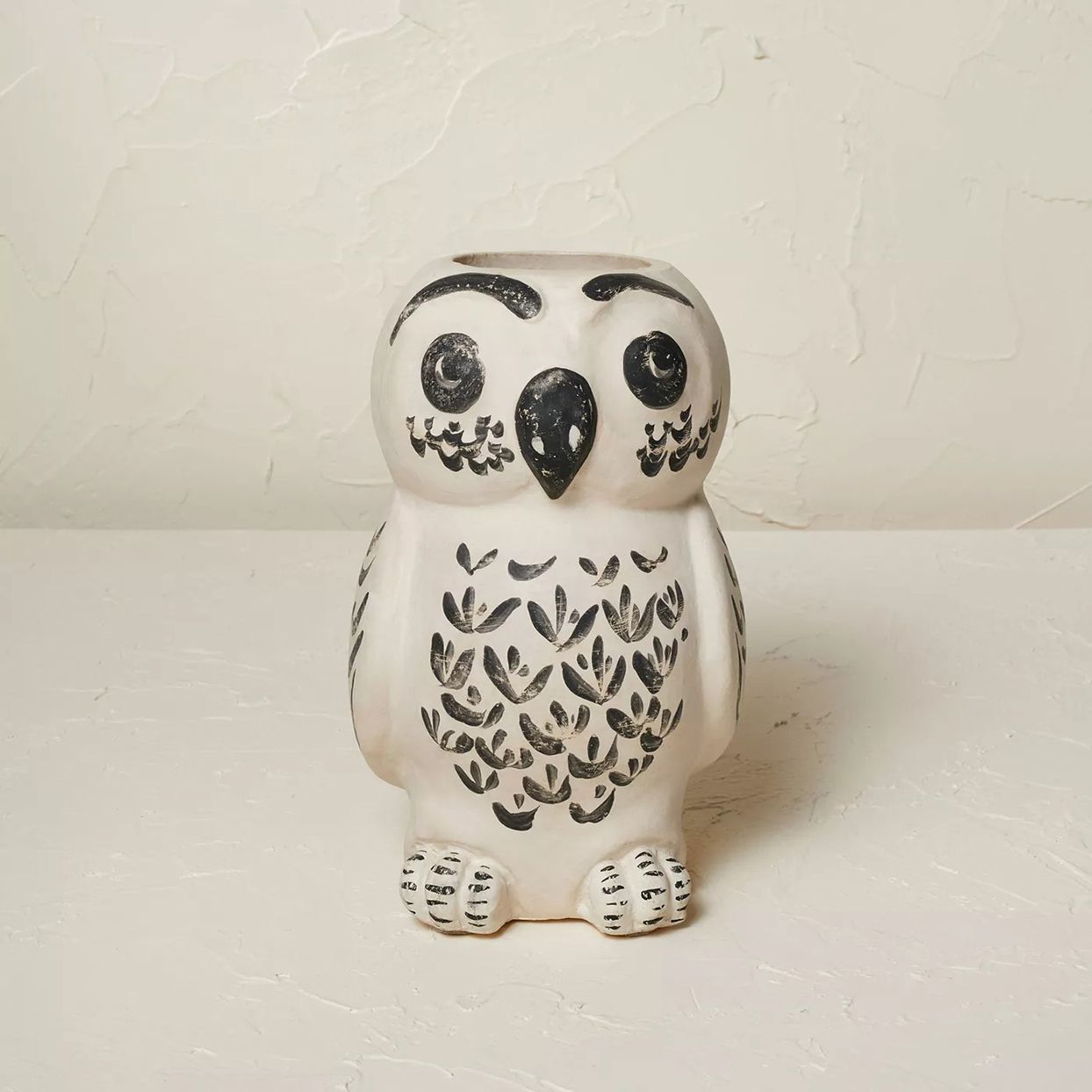 white owl figurine with black painted details