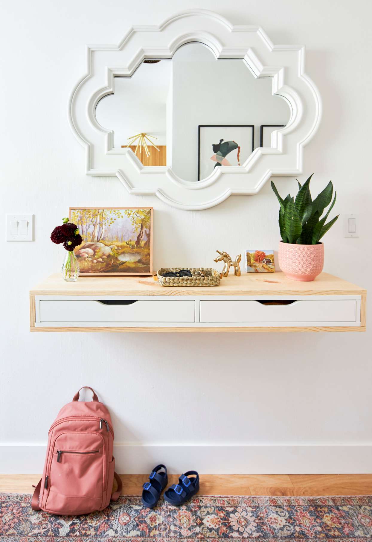 wall with mirror and floating shelf