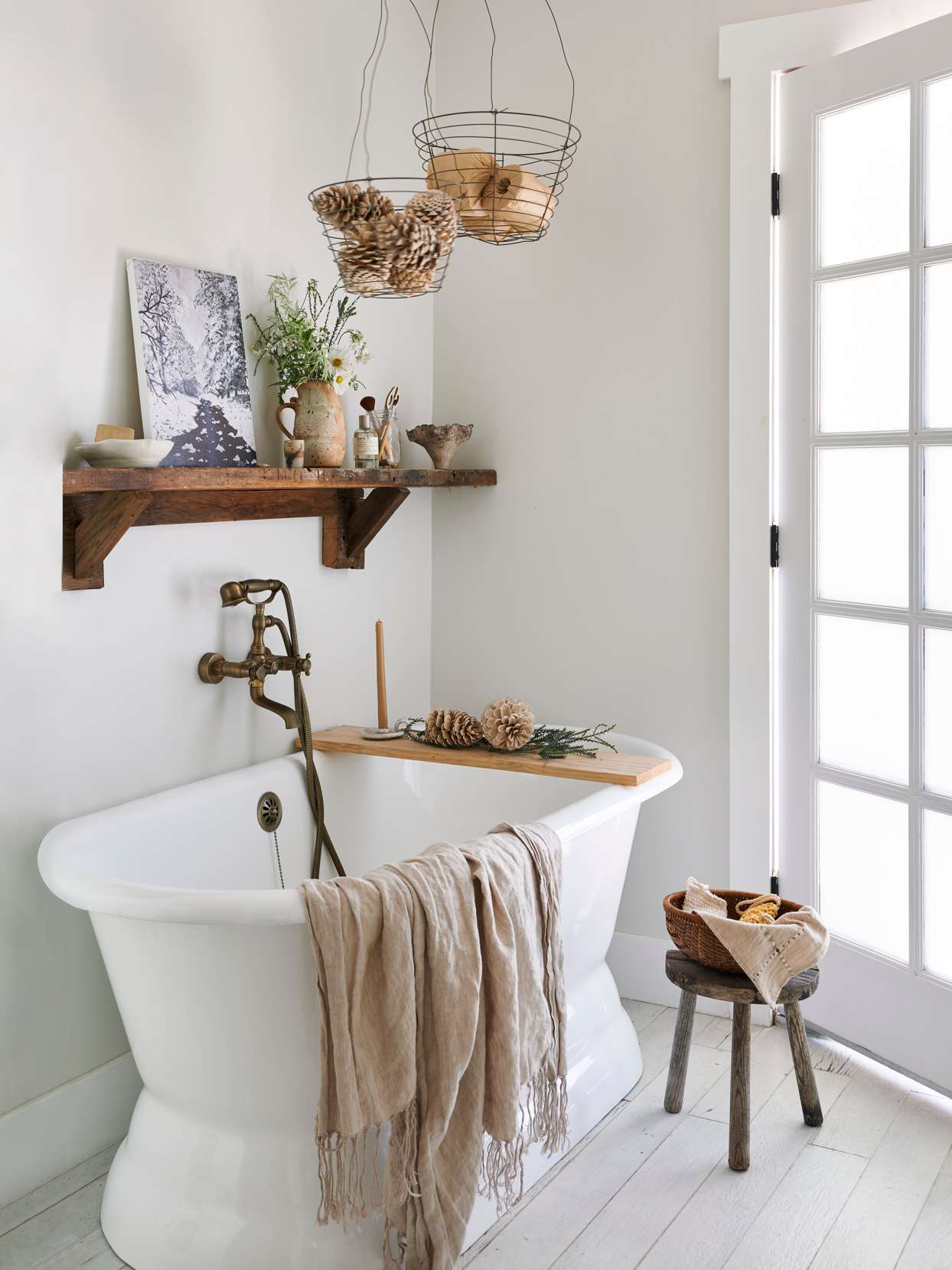 minimalist white bathroom with wood accents and pinecone decor