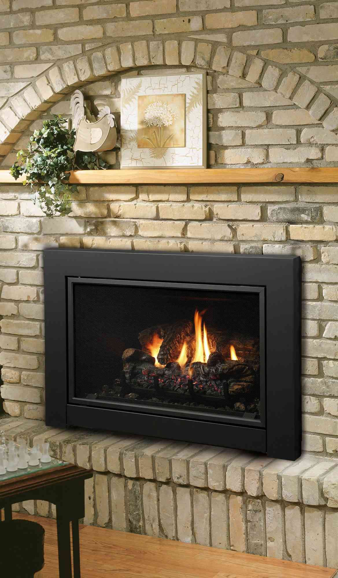 gas fireplace insert with white brick fireplace surround