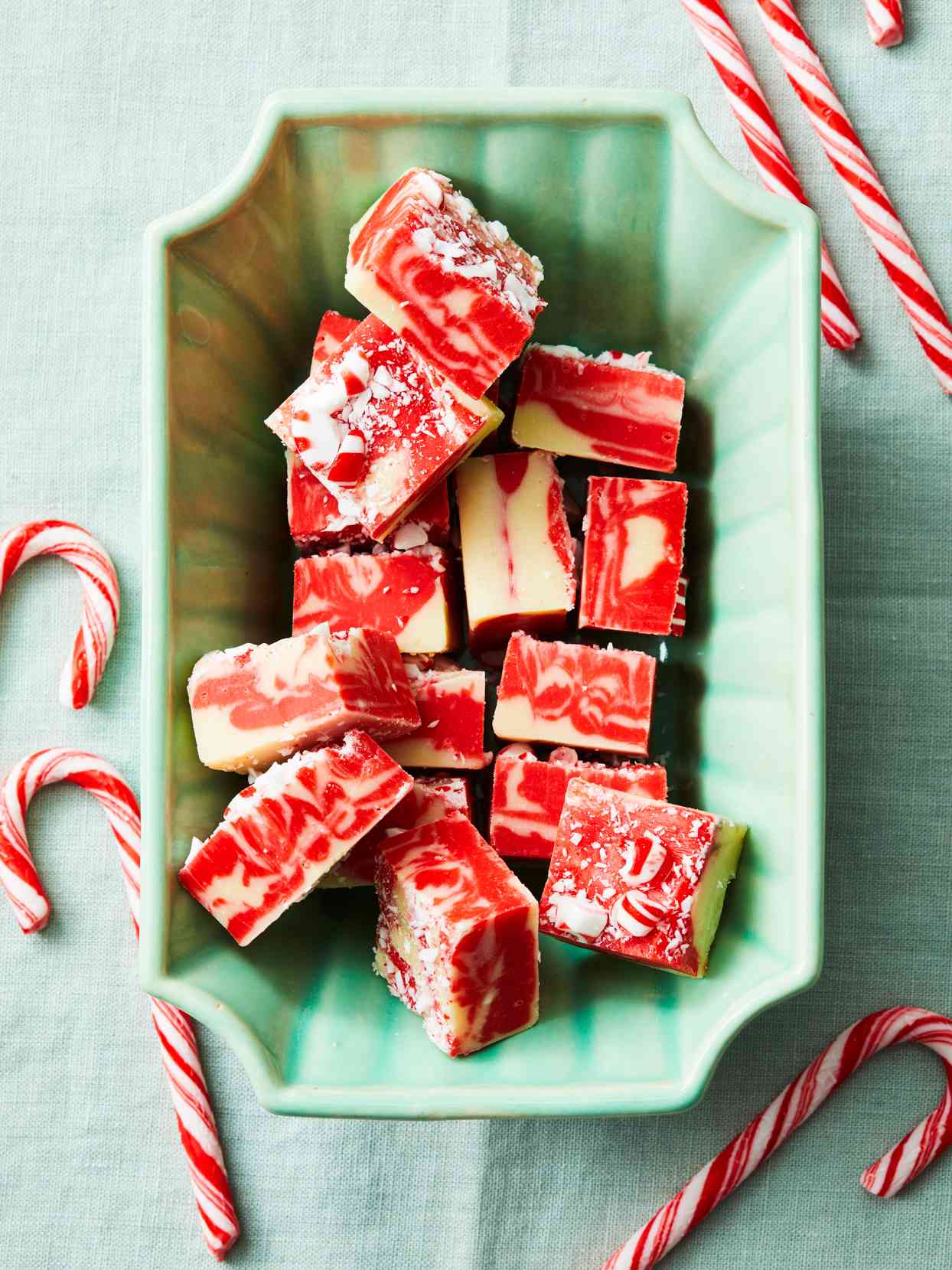 Candy Cane Swirl Fudge in green dish and candy canes on the side