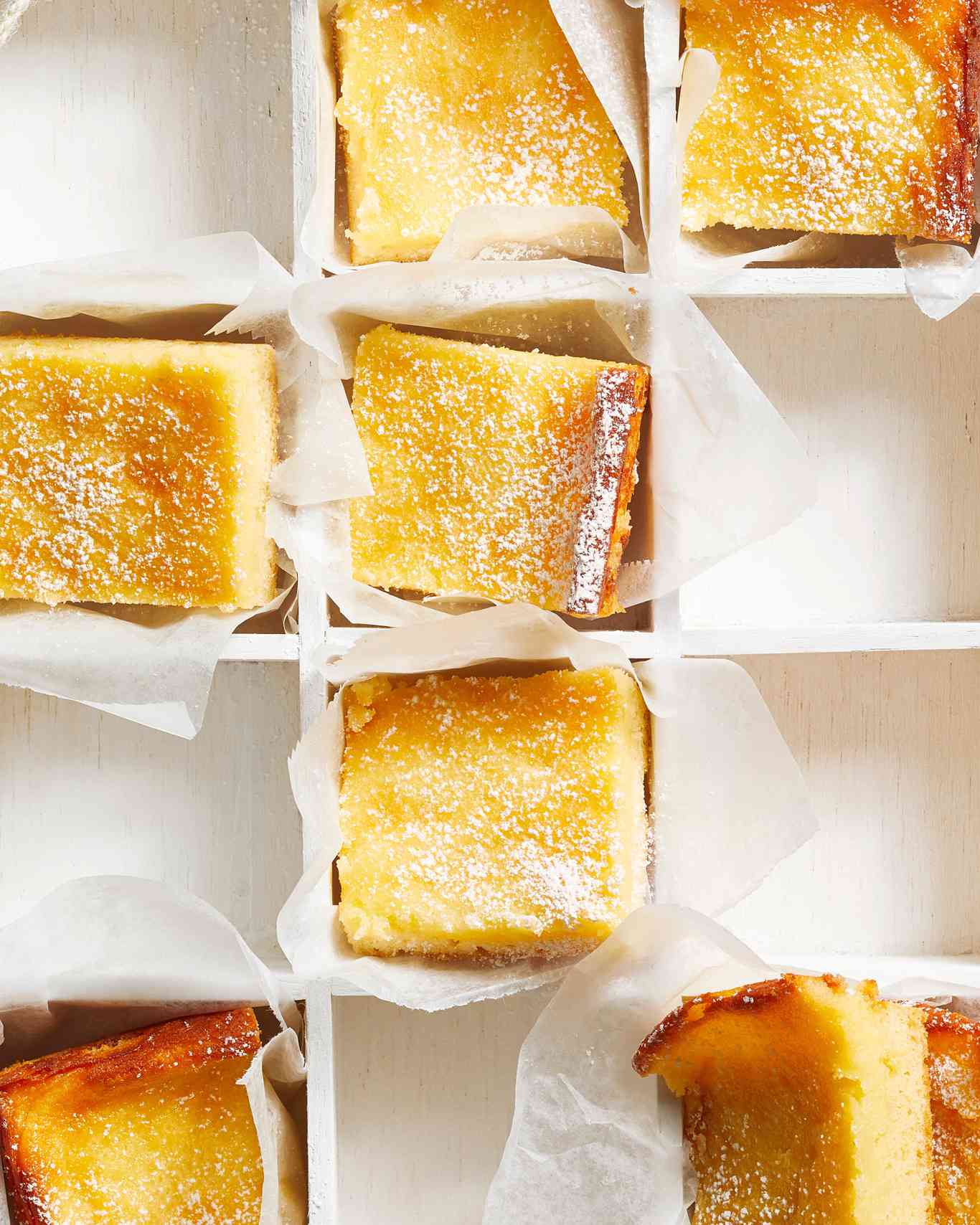 Gooey Butter Cake Squares in box with parchment paper