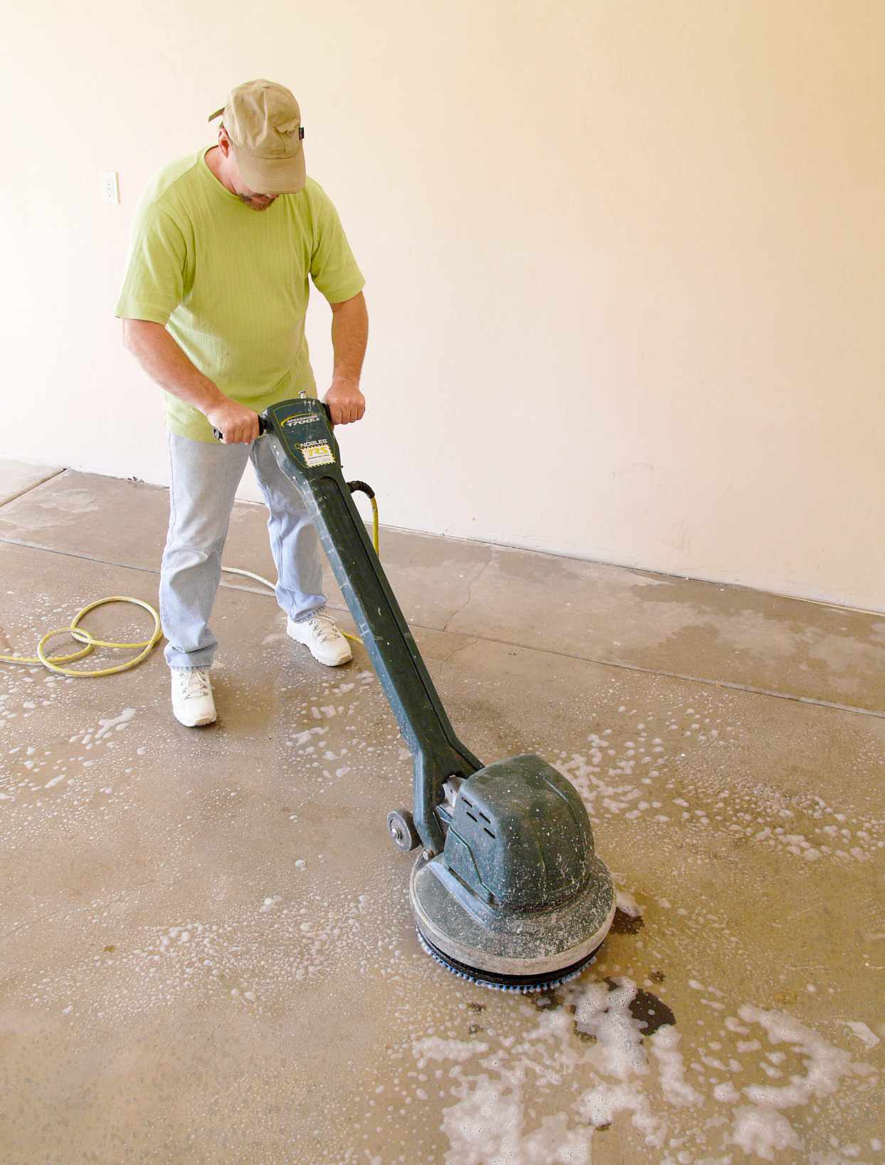 using power scrubber on concrete floor no text