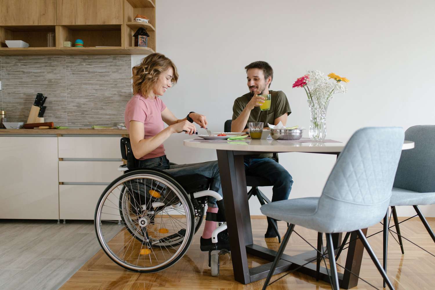 woman in wheelchair at kitchen table