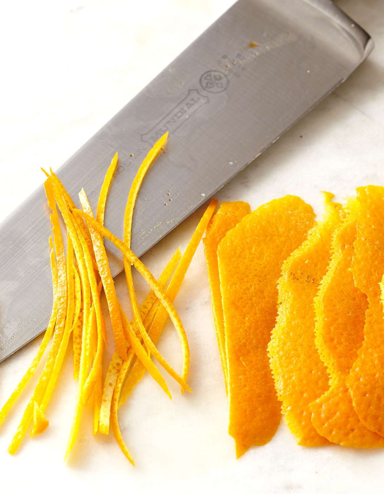 slices of orange peel with knife