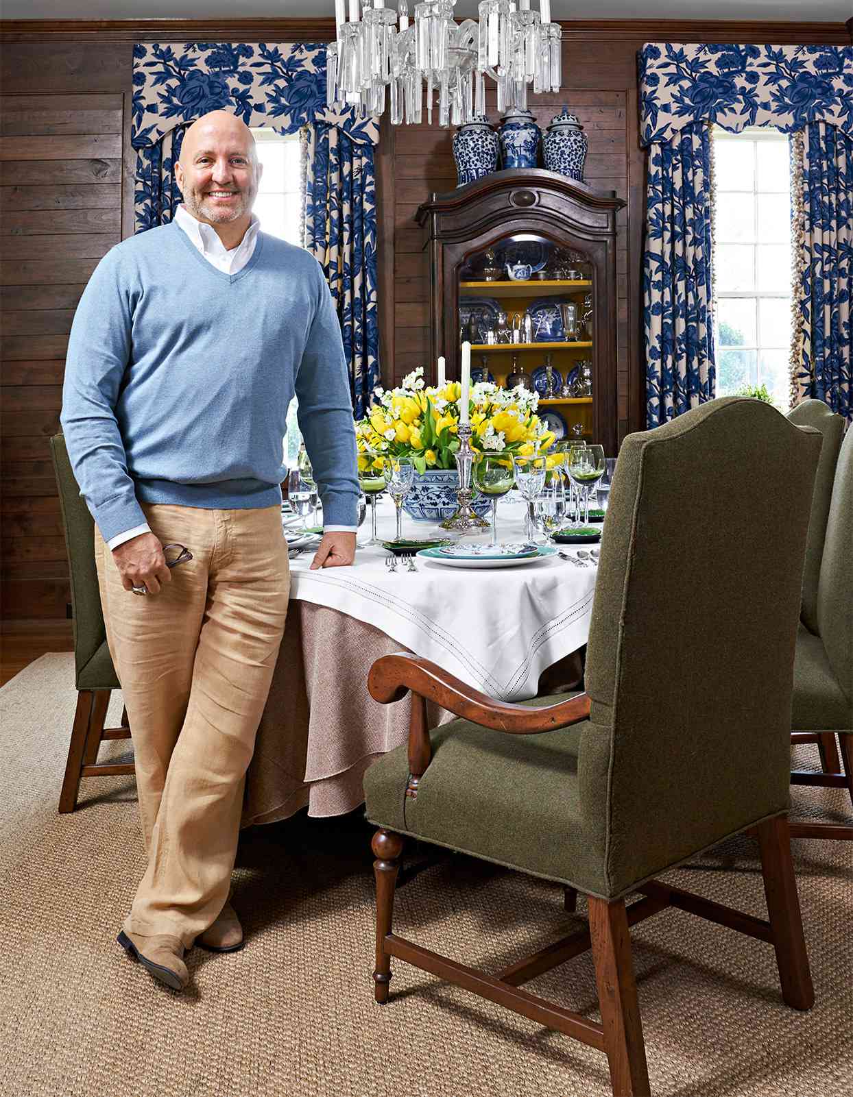 designer roger higgins dining room table blue curtains wood paneling