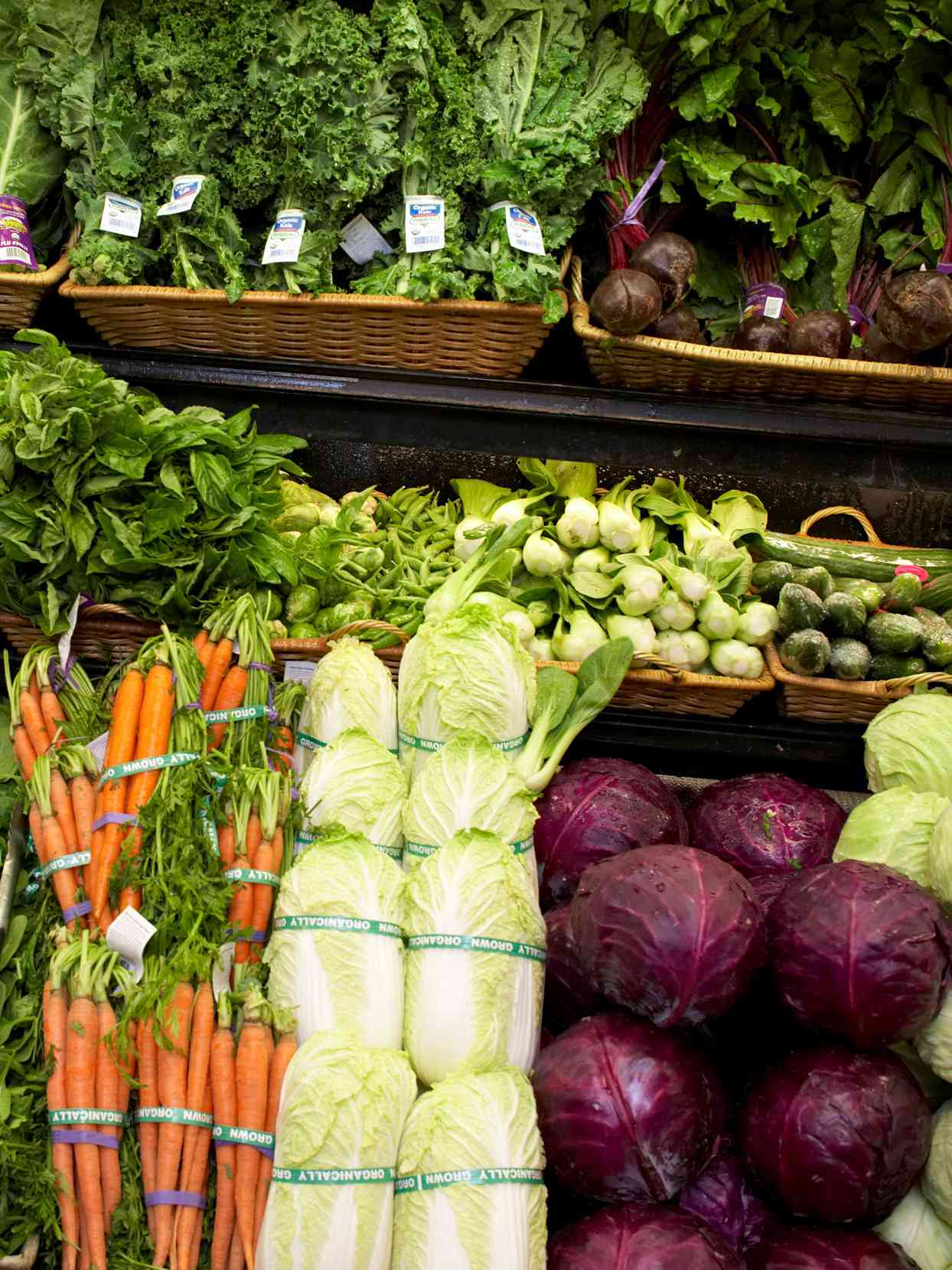 cabbage and other produce on stand