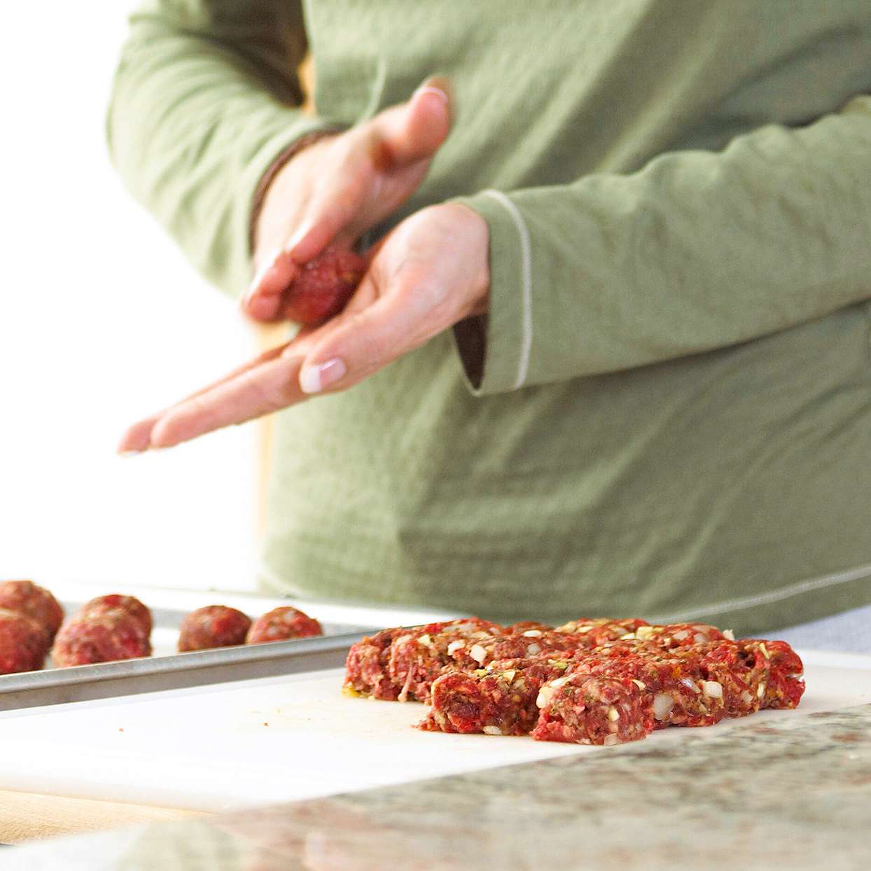 rolling out meatballs into balls hands