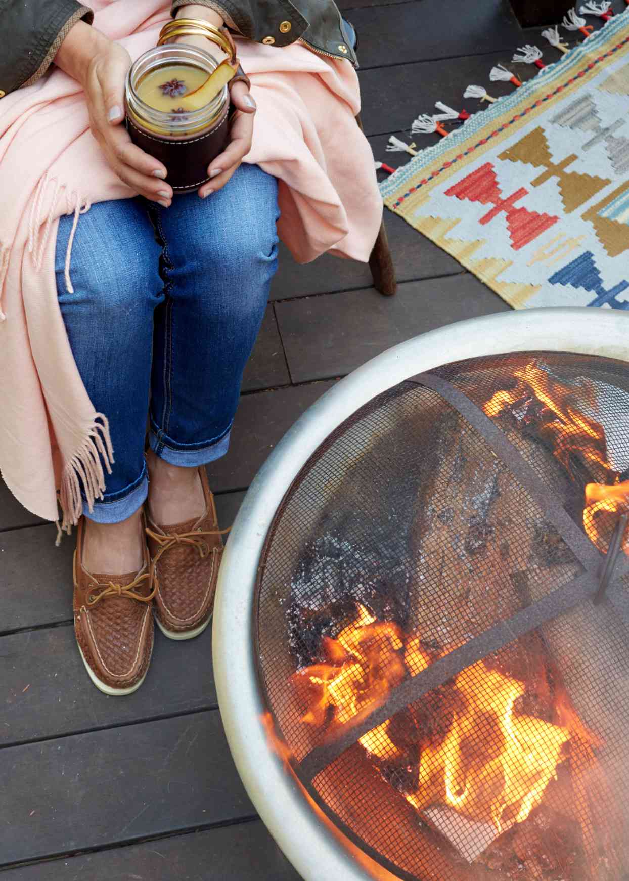 fire pit entertaining with cocktails and blankets