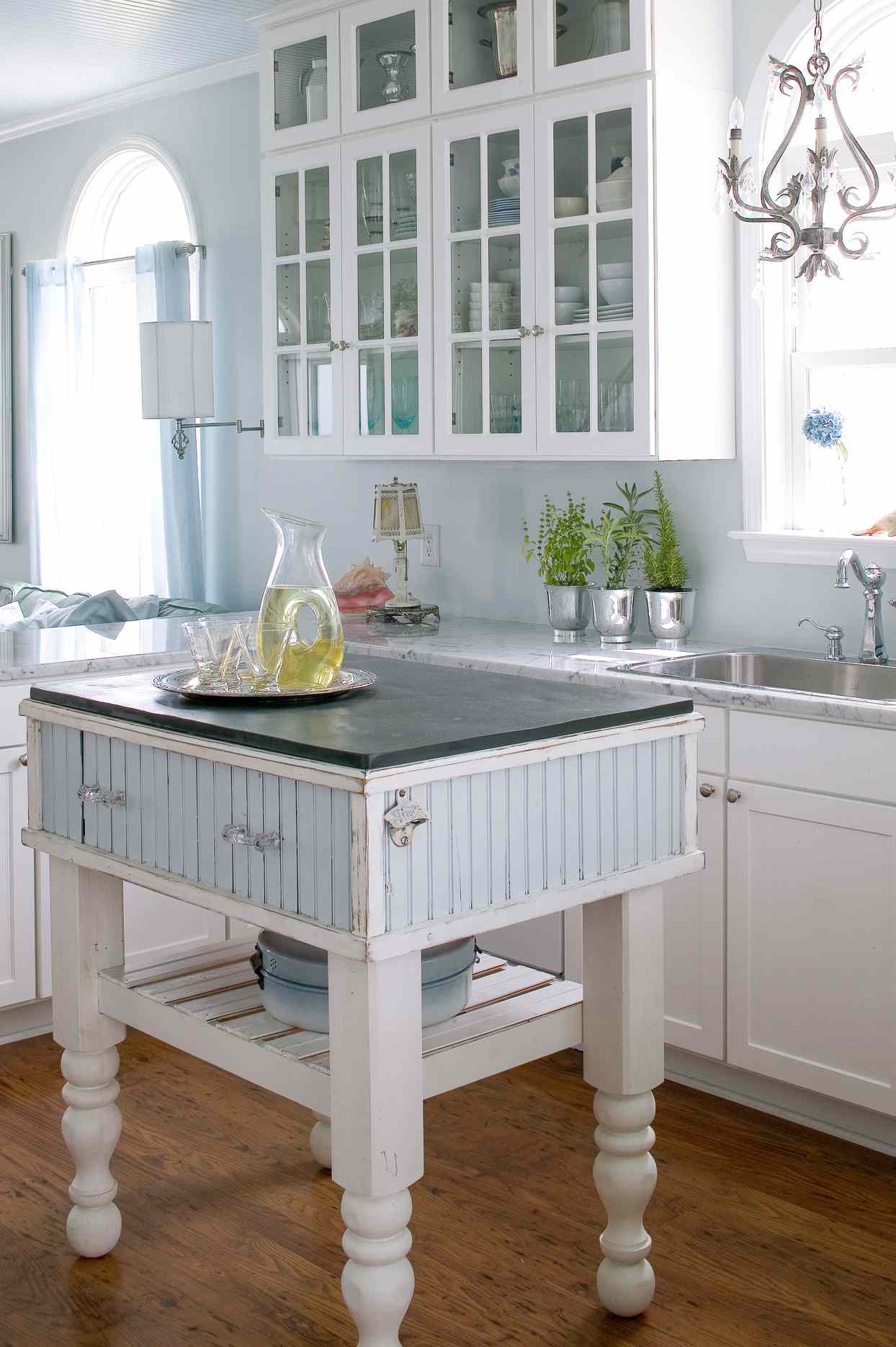 white tin kitchen island glass cupboards