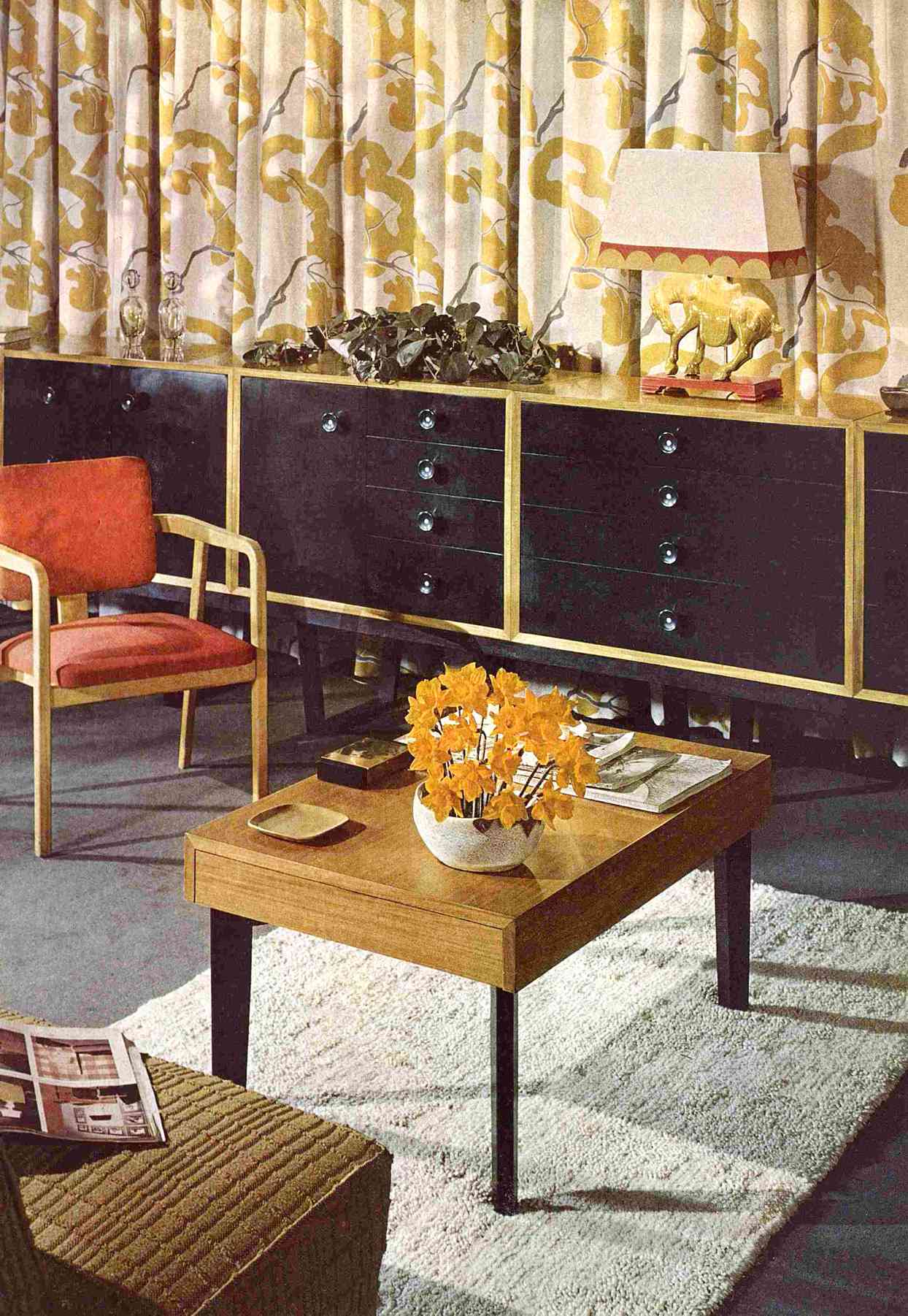 100 years interior design 1940s living room floral curtains black cabinets lamp orange chair rug coffee table