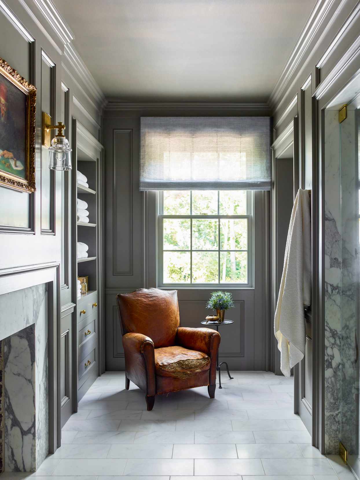 bathroom with fireplace and antique leather chair