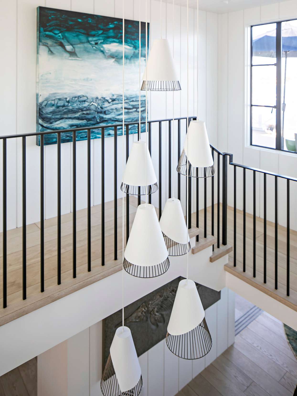 modern hanging light fixture above staircase