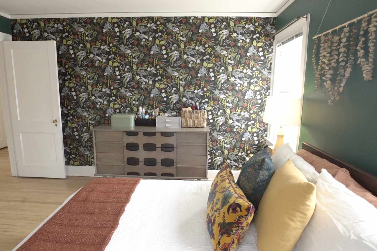 Interior view of bedroom with floral wallpaper and dark green wall from Episode 3 Owning It filmed in New Jersey