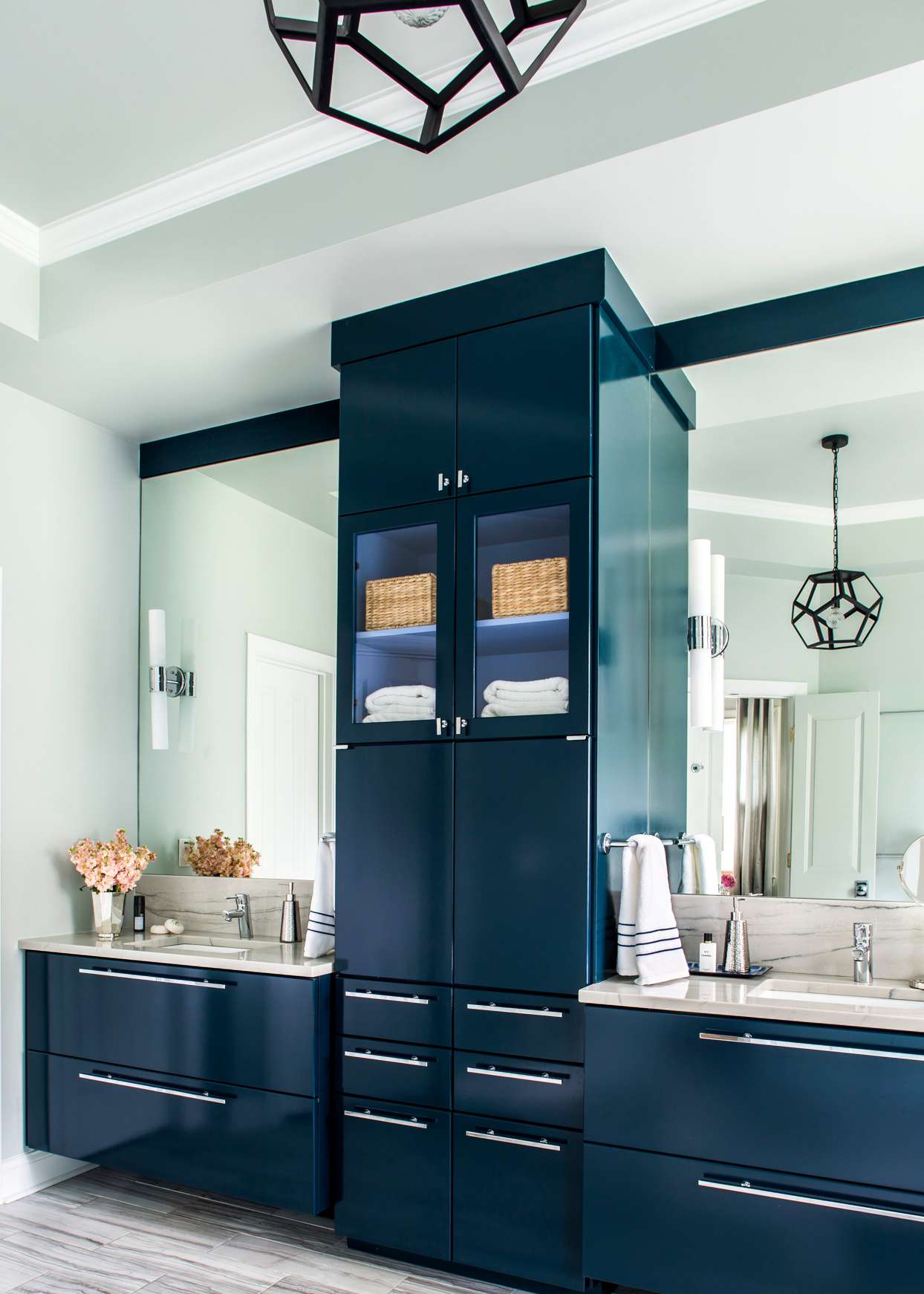 dark blue cabinetry with his and hers vanities