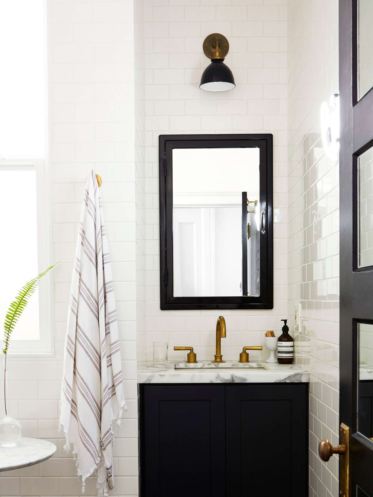 black corner vanity with hanging mirror