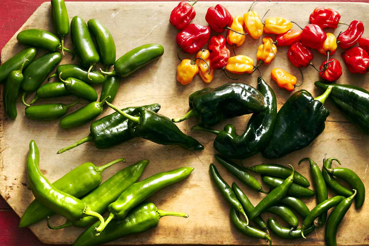 variety of hot peppers on cutting board