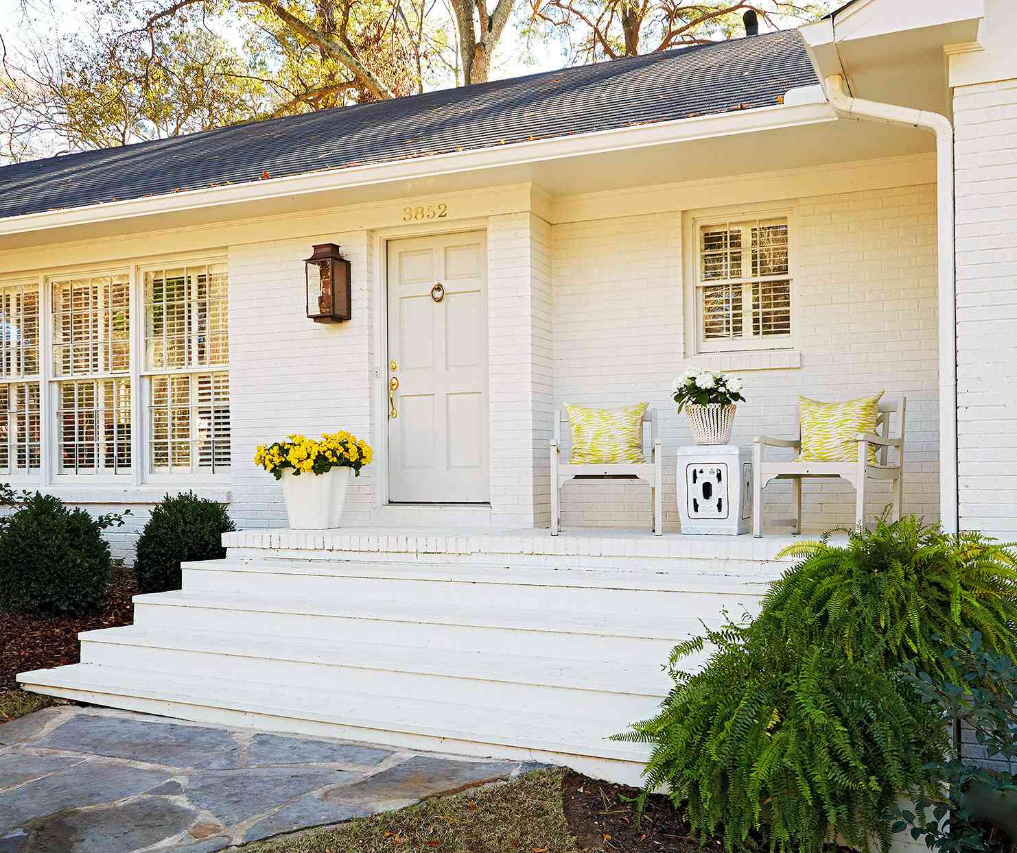 white painted brick ranch exterior front porch steps yellow