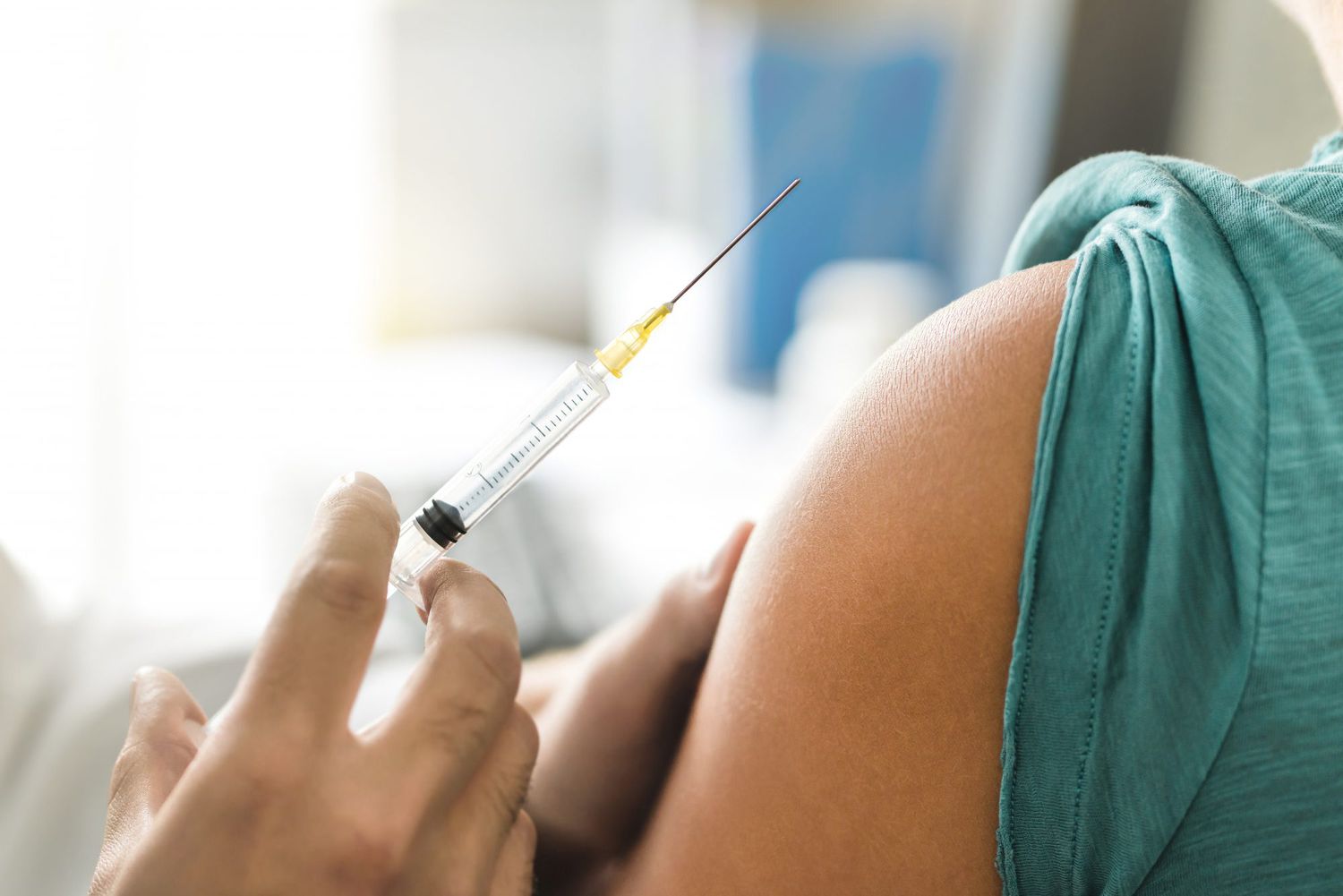 Vaccine or flu shot in injection needle. Doctor working with patient's arm. Physician or nurse giving vaccination and immunity to virus, influenza or HPV with syringe.