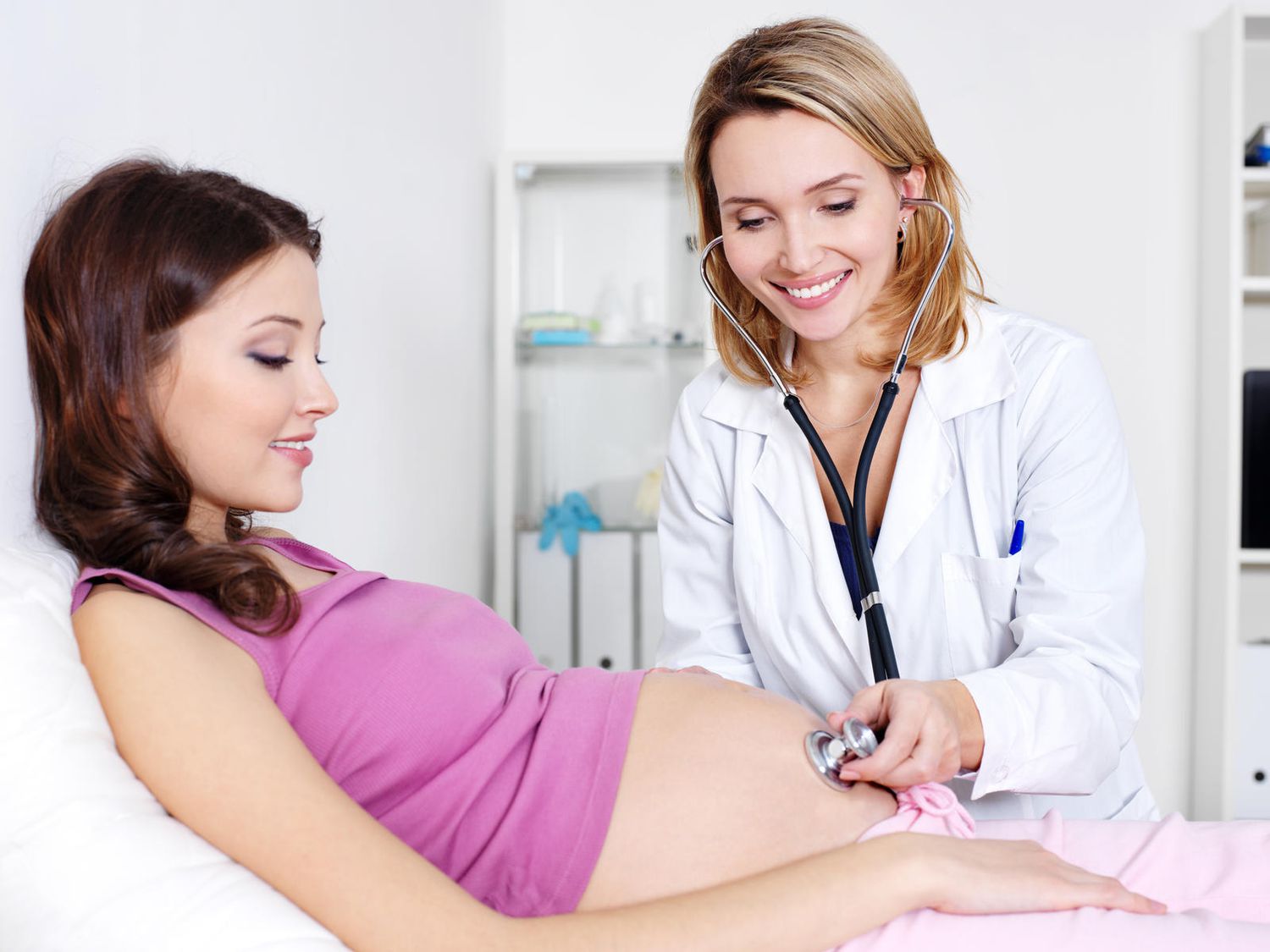 Pregnant Woman with Doctor Listening to Belly