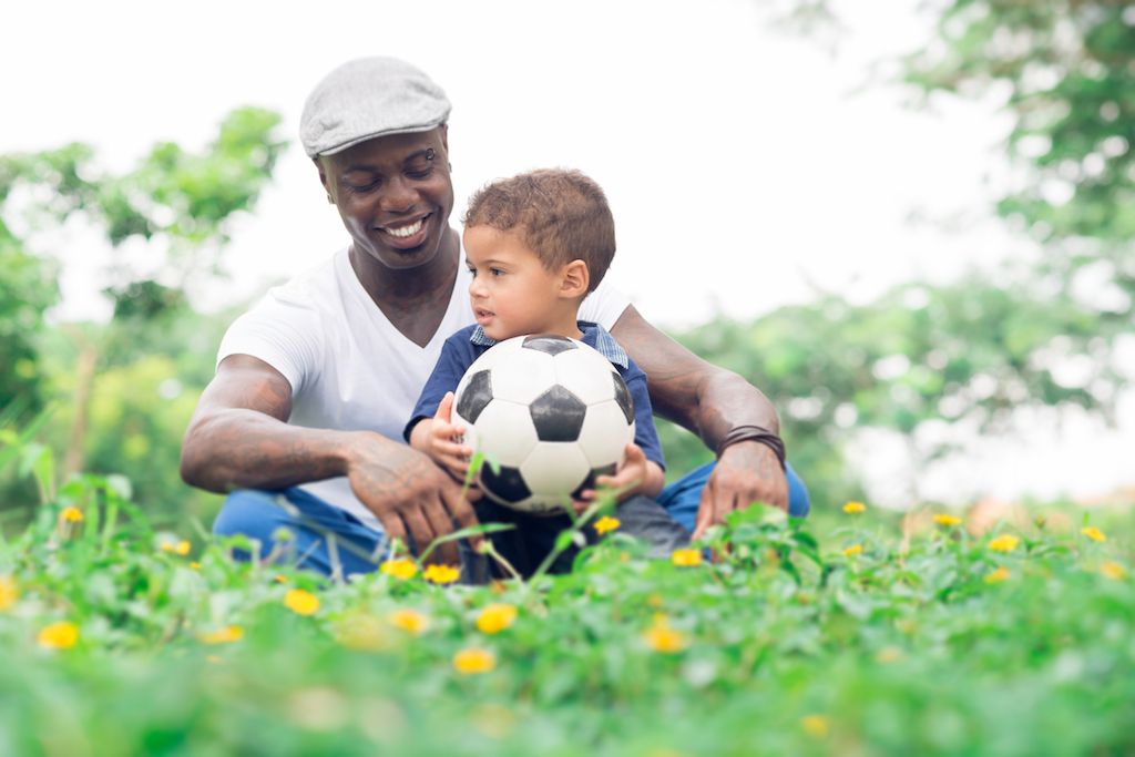dad with son and soccer ball