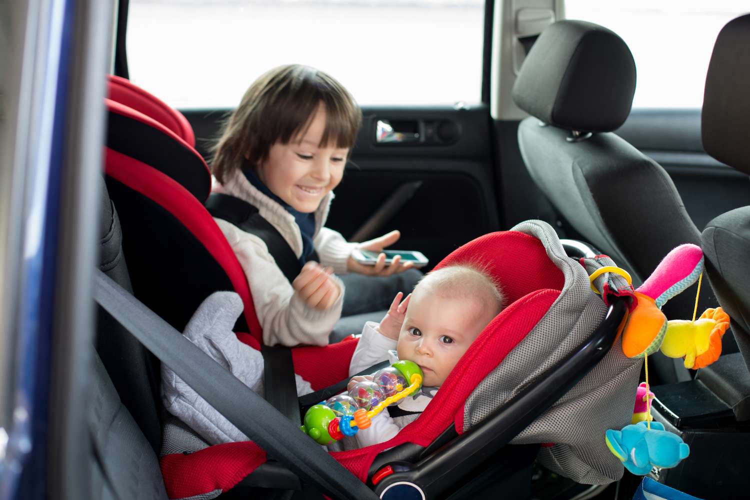 baby and toddler in car seat