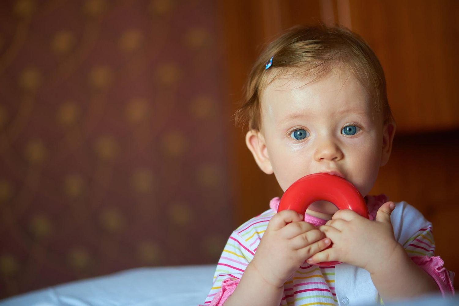 Baby with Blue Eyes and Teething Ring
