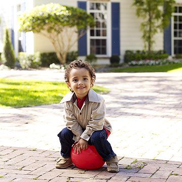 child sitting outside on ball