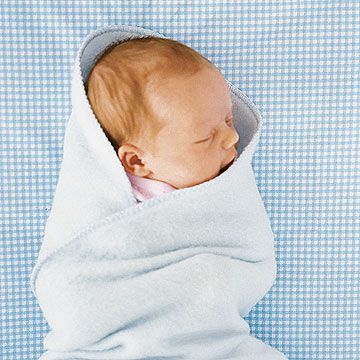 Baby wrapped in blue blanket