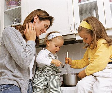 mother cooking with daughters