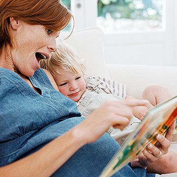 pregnant woman reading to son