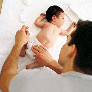 father changing baby's diaper