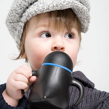 toddler holding sippy cup