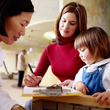 Mother and child filling out paperwork
