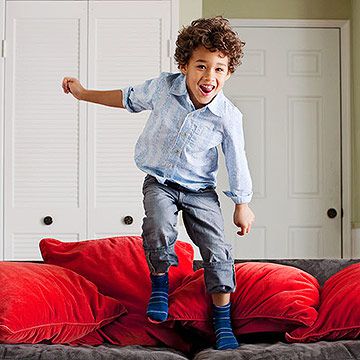 child jumping on couch