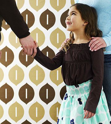Child shaking hands with adult