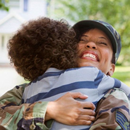 returning soldier hugging her son