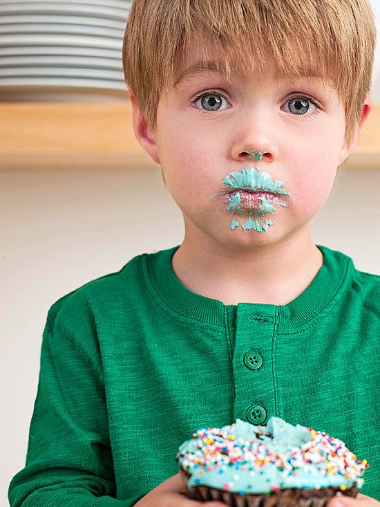 boy with cupcake frosting on face