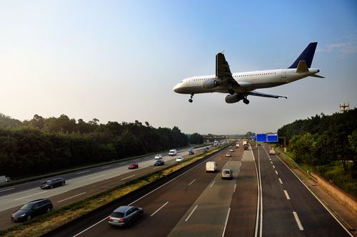 Plane flying over a highway