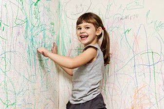 Girl coloring with crayon on walls 36291