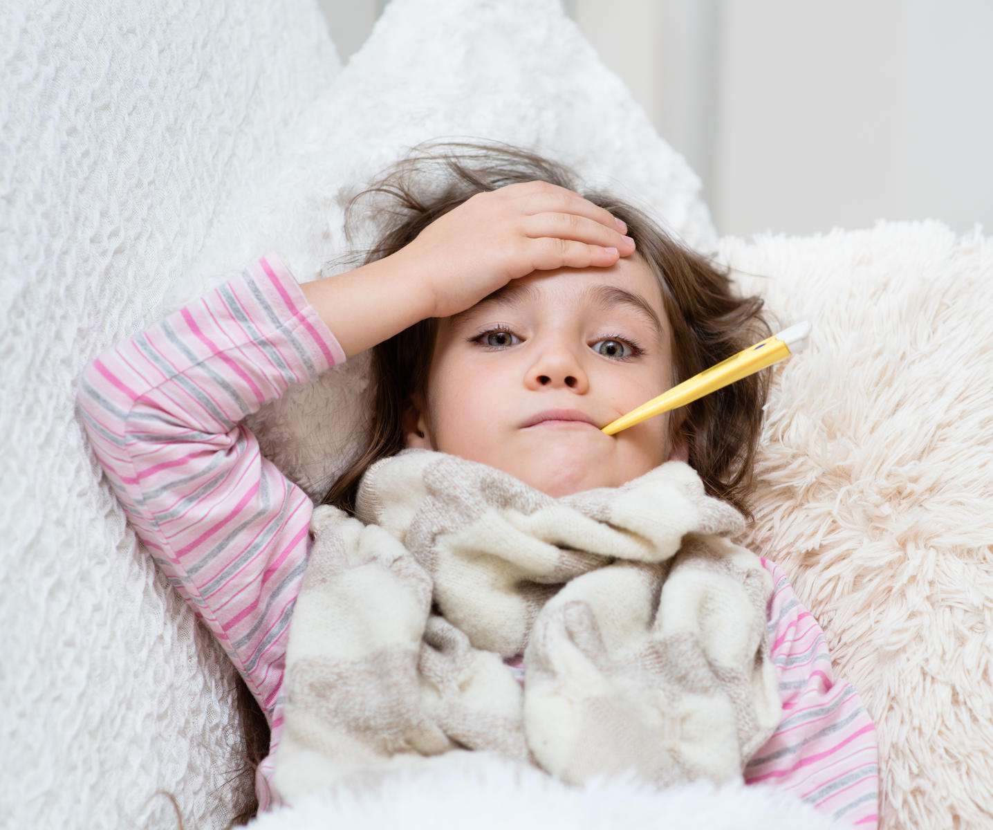sick child with thermometer 