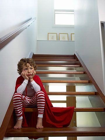 boy sitting on the stairs being punished