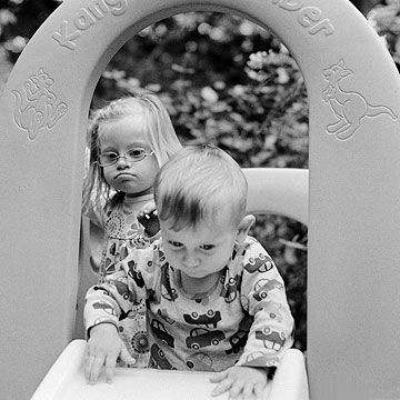 Johanna and Teddy play on the slide