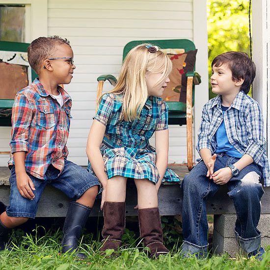 Kids in plaid talking on porch