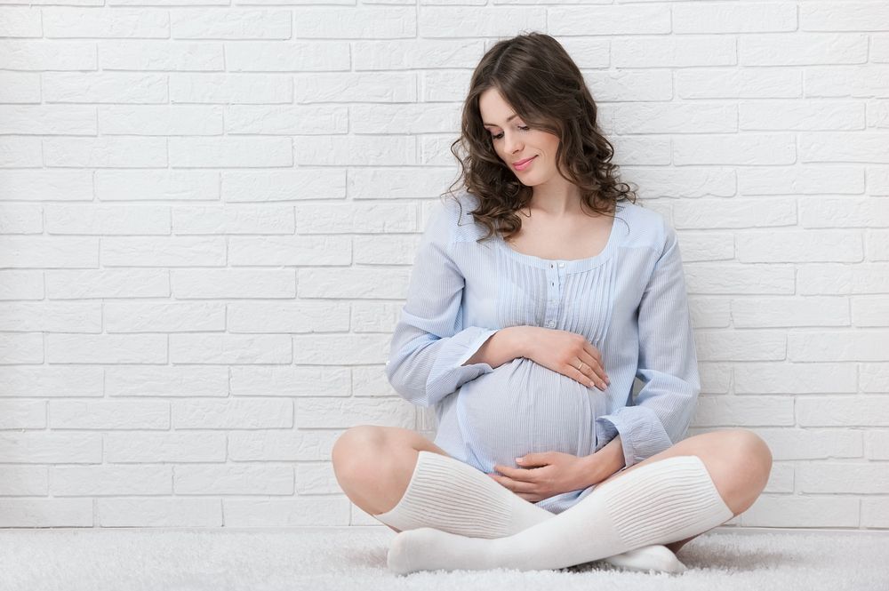 Pregnant Woman Looking at Stomach