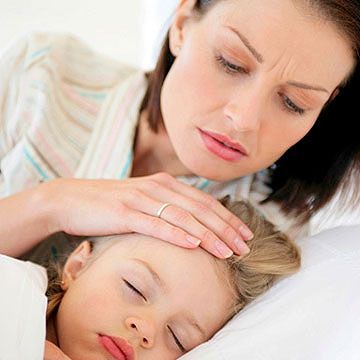 mother checking daughter's fever