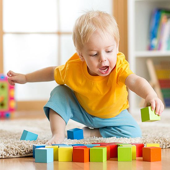 toddler playing wooden blocks