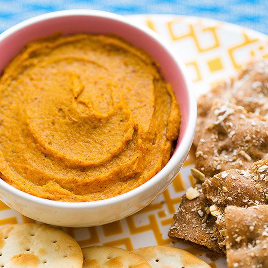 Pumpkin nut butter in bowl with crackers beside it